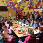 Children around a table with their artwork